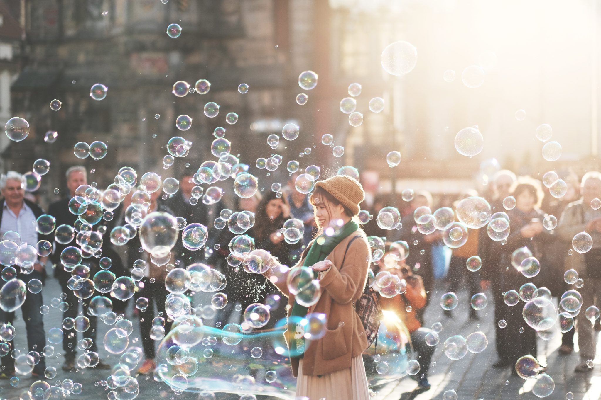 Woman in crowd surrounded by bubbles