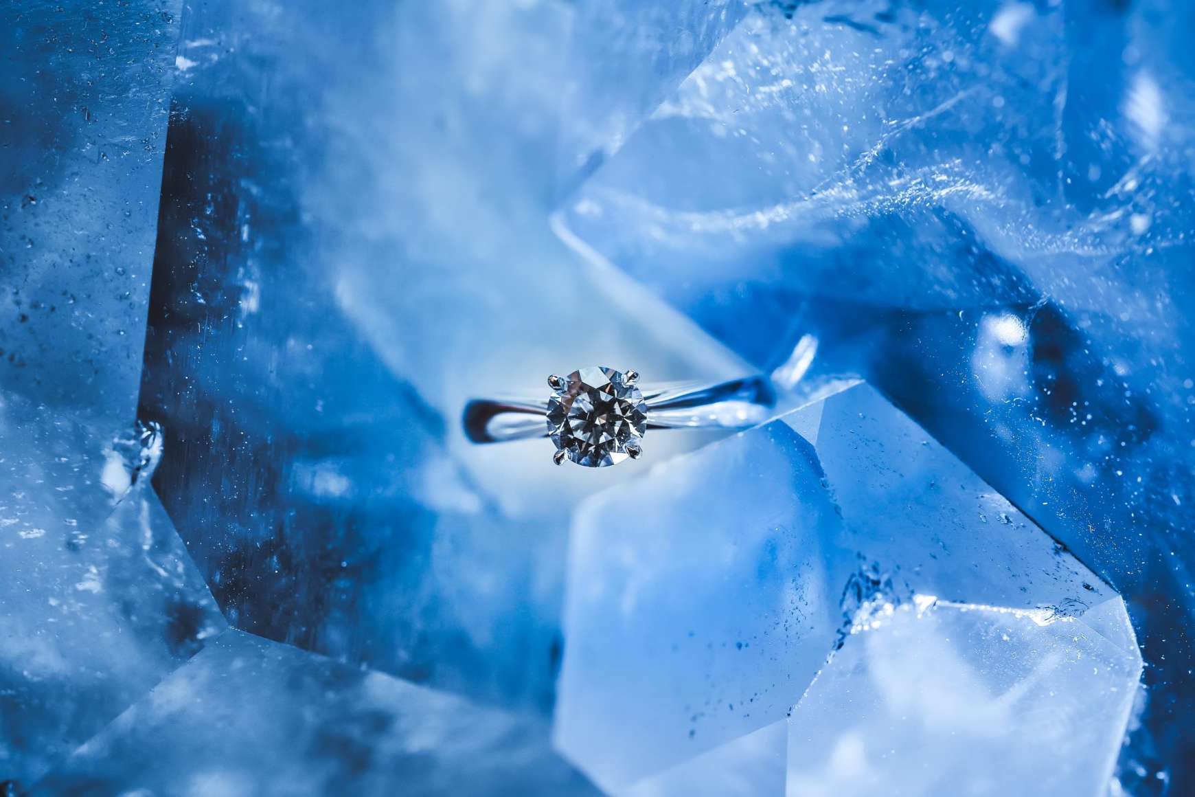 silver diamond ring on a blue hunk of ice