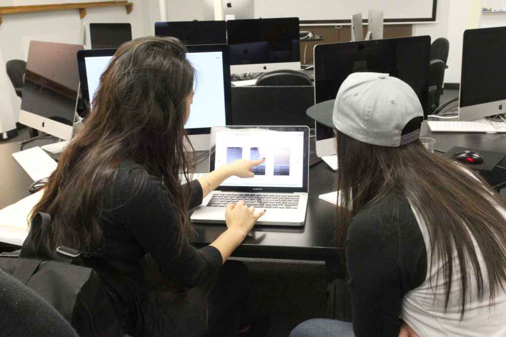 Web Design New Media interviewer and student on computer