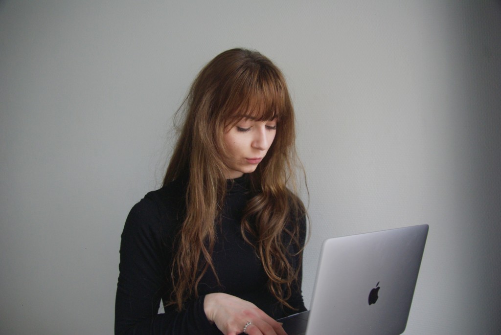 Woman working on a Mac laptop