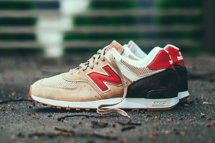White New Balance 576 sneakers with red and black detailing